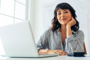 woman smiling at computer desk